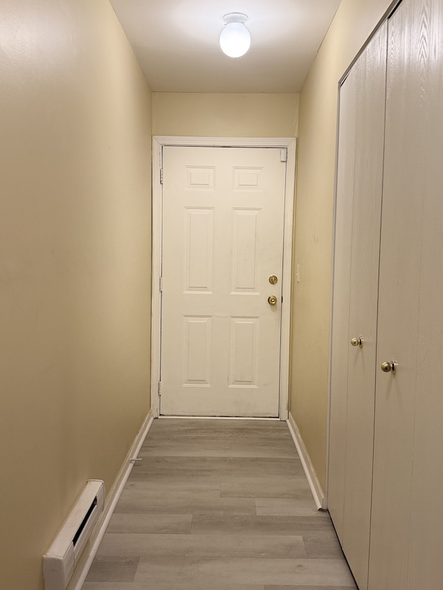 entryway featuring a baseboard heating unit and light hardwood / wood-style flooring