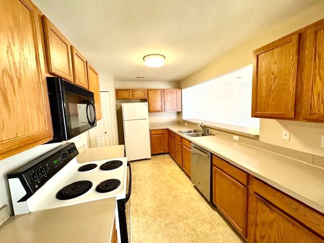 kitchen featuring sink and white appliances