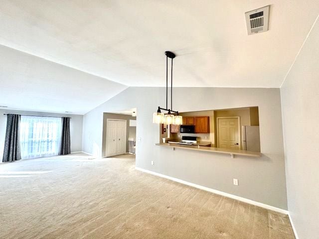 unfurnished living room with light carpet and vaulted ceiling