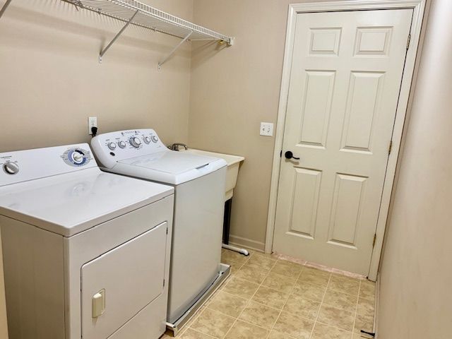 clothes washing area with washer and dryer