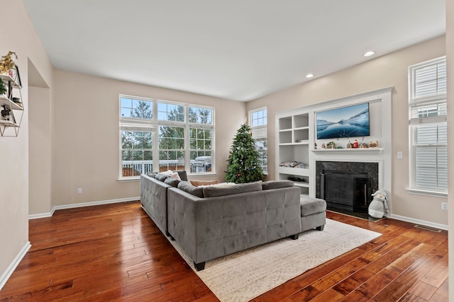 living room with hardwood / wood-style floors and built in features