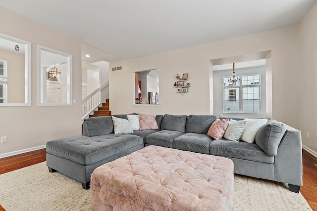 living room featuring a notable chandelier and hardwood / wood-style flooring