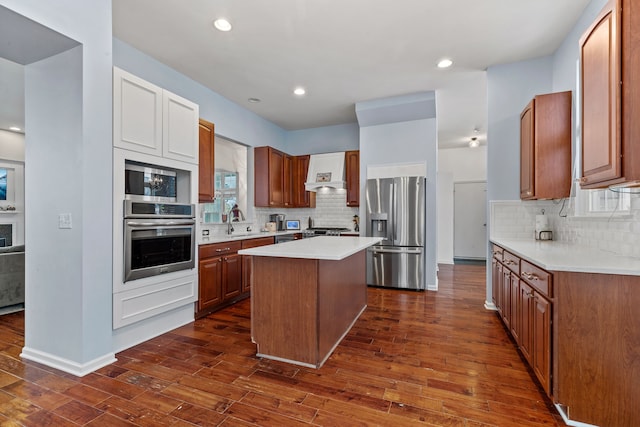 kitchen with a center island, premium range hood, dark wood-type flooring, sink, and appliances with stainless steel finishes