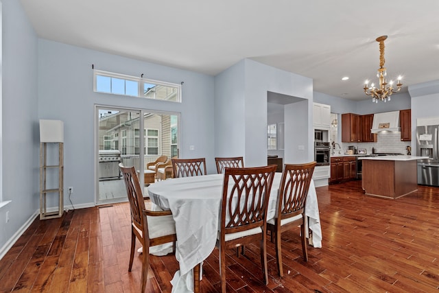 dining space with a chandelier and dark wood-type flooring