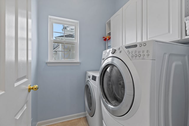 laundry room featuring cabinets and washer and dryer