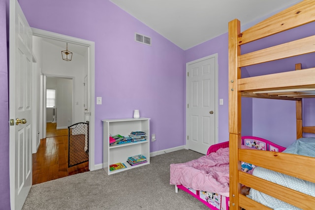 bedroom featuring carpet floors and vaulted ceiling