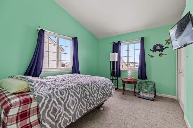 bedroom featuring carpet floors, vaulted ceiling, and multiple windows