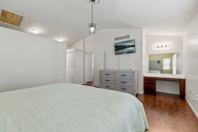 bedroom with lofted ceiling and dark wood-type flooring