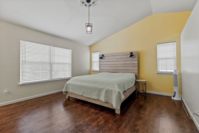 bedroom with a baseboard radiator, dark wood-type flooring, and lofted ceiling