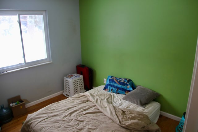 bedroom with wood-type flooring