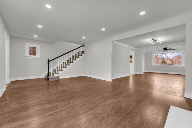 unfurnished living room featuring ceiling fan and dark hardwood / wood-style floors