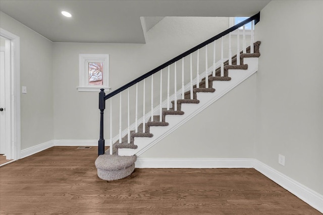 staircase featuring hardwood / wood-style flooring