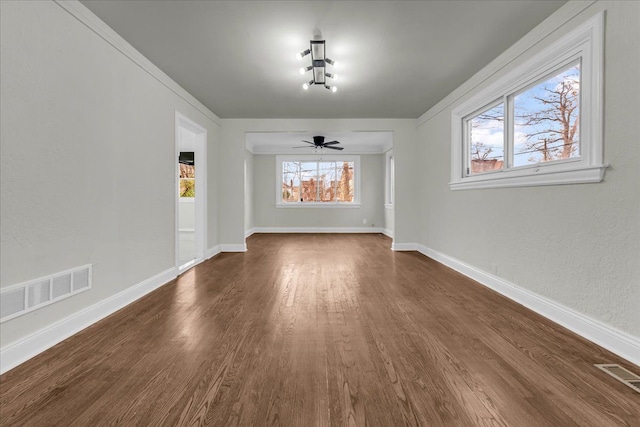 unfurnished dining area with ceiling fan and dark hardwood / wood-style flooring