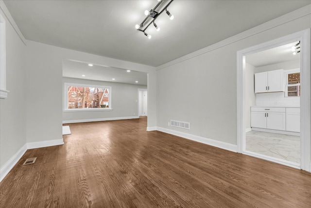 unfurnished living room with wood-type flooring