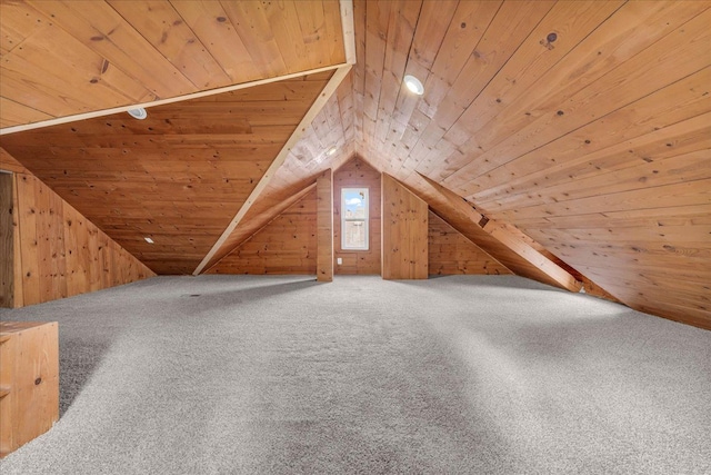 additional living space featuring wooden walls and wood ceiling