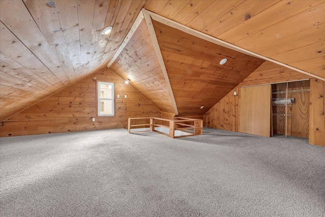 bonus room featuring carpet flooring, wood walls, and wooden ceiling