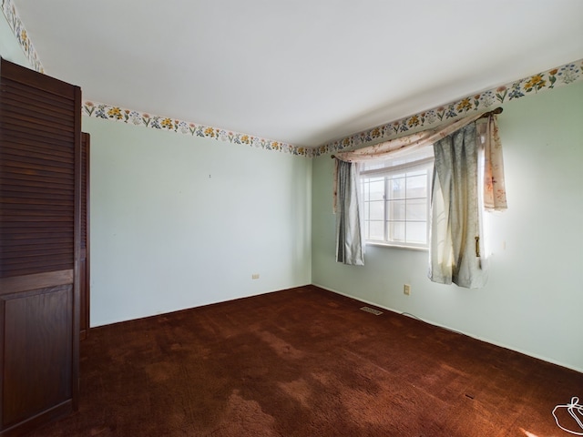 empty room with dark carpet