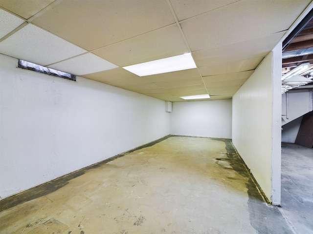 basement with a paneled ceiling