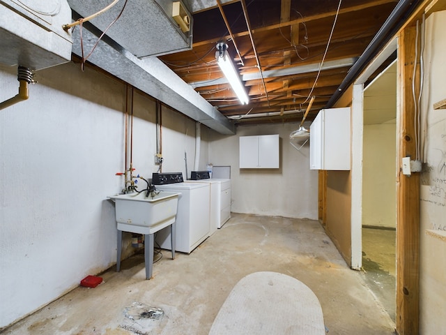 basement featuring independent washer and dryer and sink