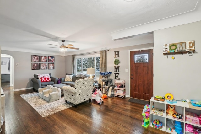 living room with dark hardwood / wood-style flooring and ceiling fan