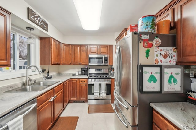 kitchen with appliances with stainless steel finishes, hanging light fixtures, and sink