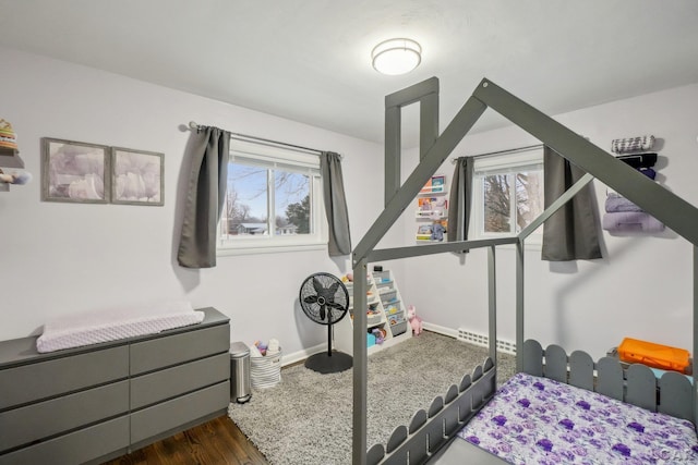 bedroom with dark hardwood / wood-style flooring