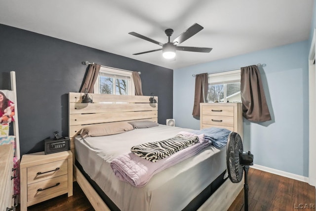 bedroom featuring a ceiling fan, baseboards, and dark wood-style floors