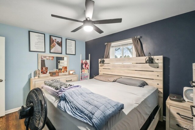 bedroom with baseboards, ceiling fan, and wood finished floors