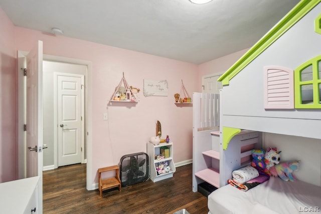 bedroom with baseboards and wood finished floors