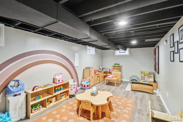 playroom with baseboards and wood finished floors