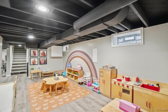 game room with light wood-type flooring