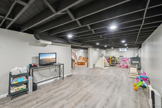 below grade area with baseboards and wood finished floors