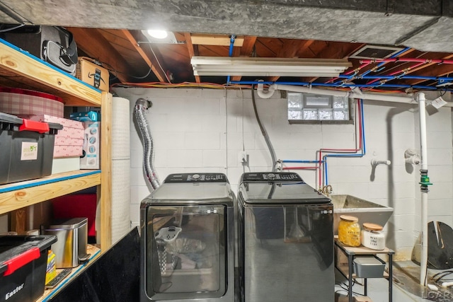 clothes washing area with washing machine and clothes dryer