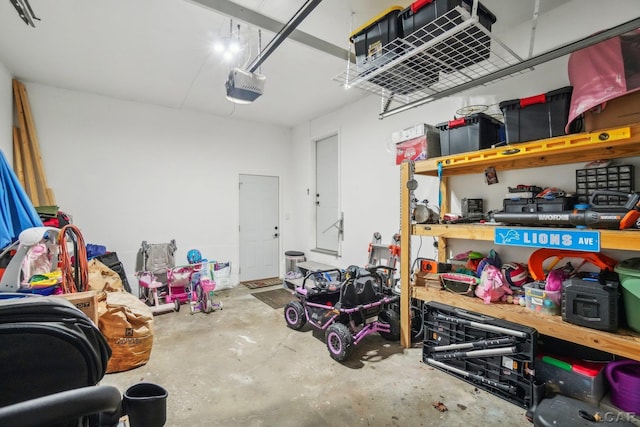 garage with a workshop area and a garage door opener