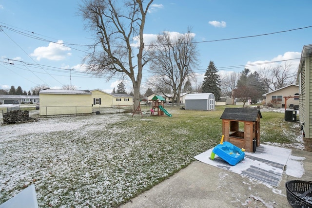 view of yard featuring a playground and a storage unit