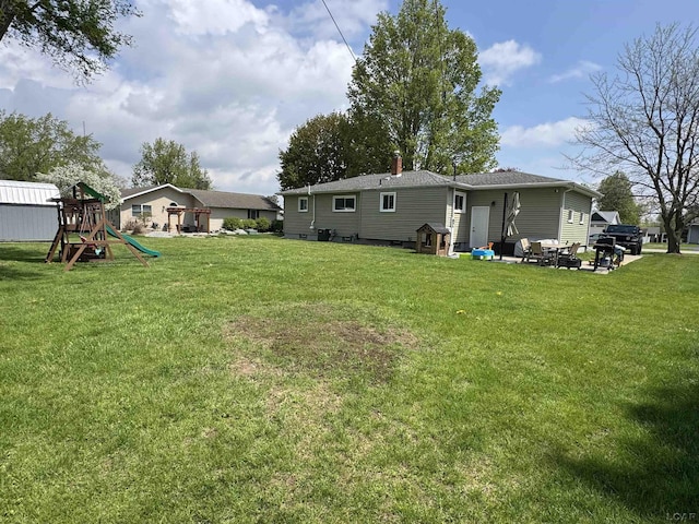 view of yard with a patio and a playground