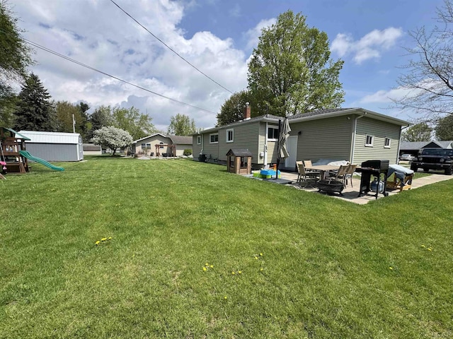 view of yard with a patio and a playground