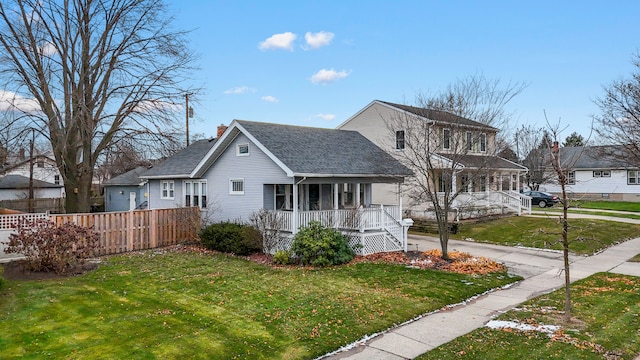 view of front of property with covered porch and a front lawn