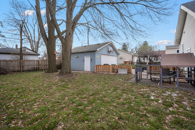 view of yard with a patio area, an outbuilding, and a garage