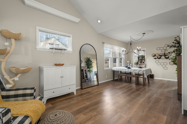 dining space with lofted ceiling, dark hardwood / wood-style flooring, a healthy amount of sunlight, and a notable chandelier