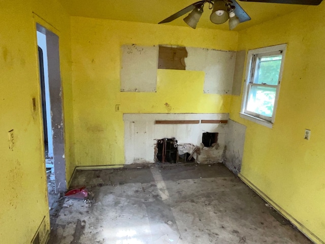 interior space featuring ceiling fan and concrete floors