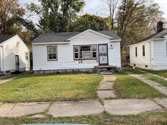 bungalow-style house with a front lawn