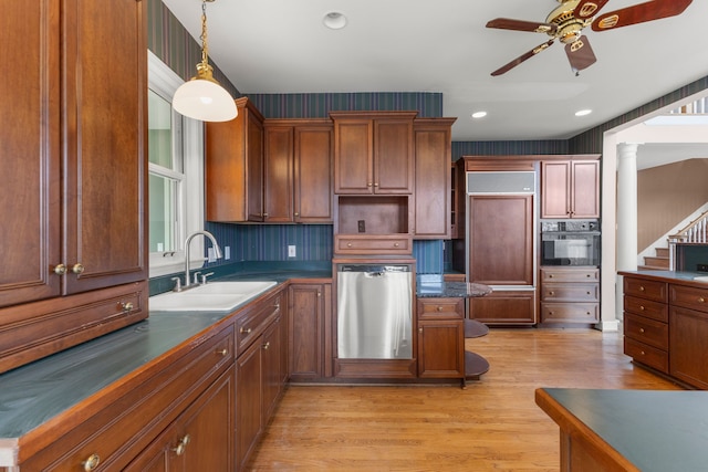 kitchen with ceiling fan, hanging light fixtures, oven, stainless steel dishwasher, and sink