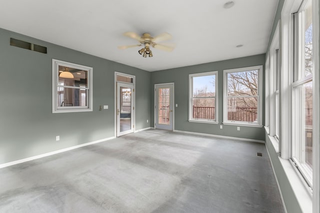 carpeted empty room featuring ceiling fan and a wealth of natural light