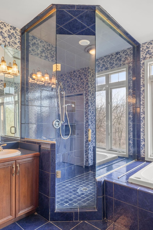 bathroom featuring tile patterned flooring, separate shower and tub, and vanity