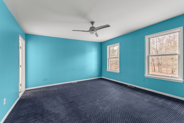 empty room with ceiling fan and carpet flooring