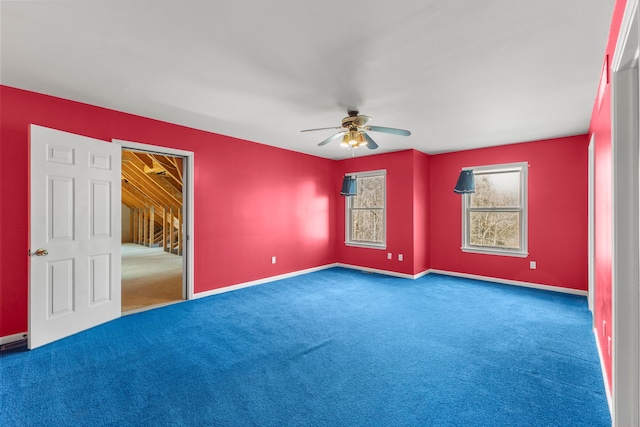 carpeted empty room featuring ceiling fan