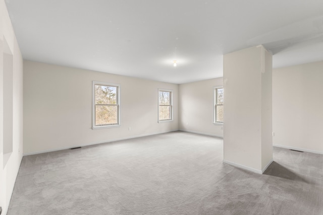 spare room featuring light colored carpet