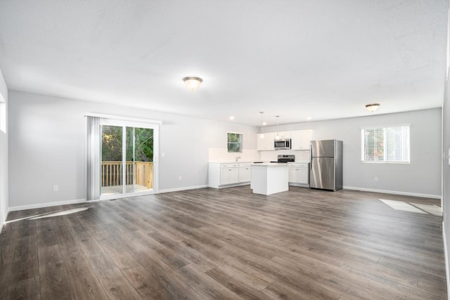 unfurnished living room with dark hardwood / wood-style flooring