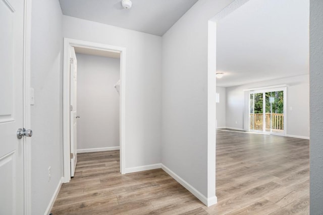 hall with light hardwood / wood-style flooring